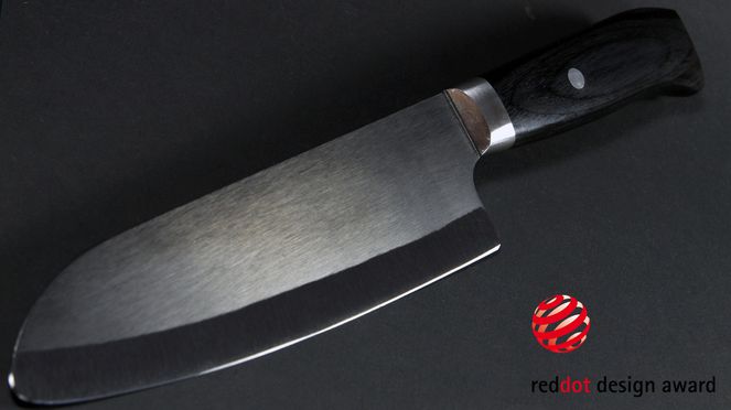 
                    The Kyocera Black Santoku with a grip of Pakka wood